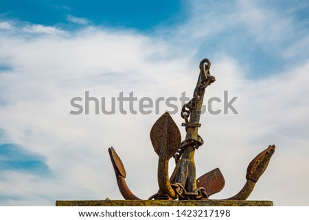 Rusted anchor in a harbor