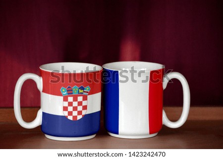 France and Croatia flag on two cups with blurry background