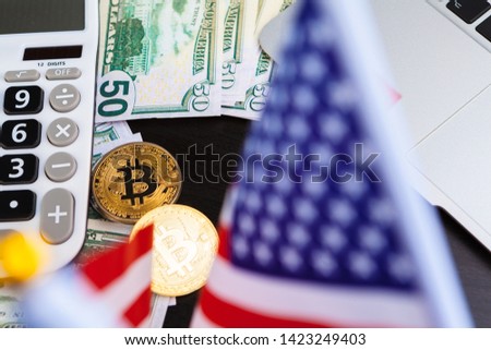 Bitcoin golden coins on a dollar banknotes office background