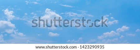 Beautiful Blue Sky Background with Tiny Clouds. Panorama Picture for Summer Season. Panoramic Banner Background.