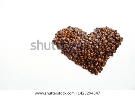 Coffee beans placed in heart shape, isolated on white background, horizontal view, suitable for coffee shops