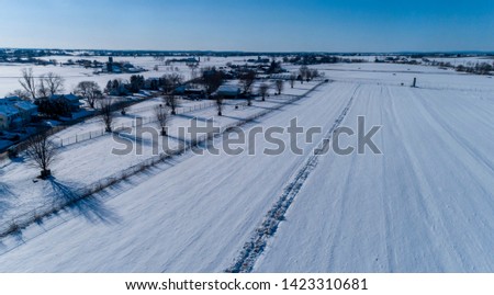 Aerial View of Morning Snow over Amish Countryside 