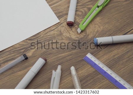 Stationary sets , pen, ruler , eraser , marker are placed on wooden background in top view
