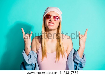 Close-up portrait of nice attractive lovely fascinating cheerful cheery girl wearing streetstyle clothing showing double horn sign isolated on bright vivid shine blue green turquoise background