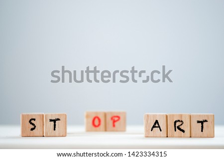 Start and stop keyword on wooden cubic. This is wording conceptual.