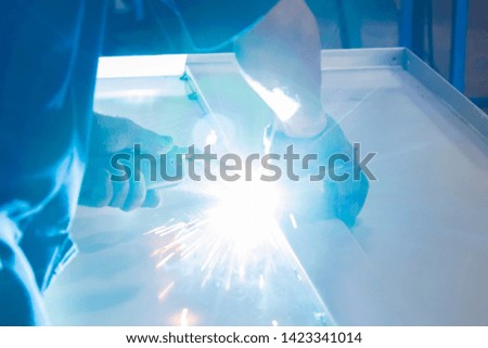 Industry worker welding iron pieces work