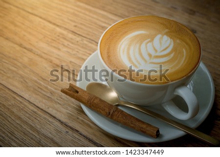 Latte art on coffee cup at table wooden background - Image