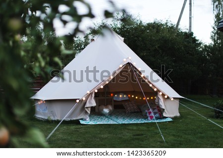 Canvas cotton Bell tent in the yard decorated for summer kids party Royalty-Free Stock Photo #1423365209