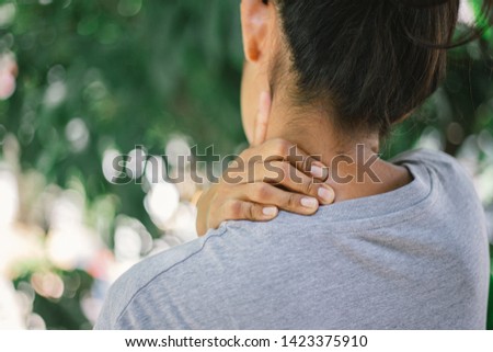 Close up young woman neck and shoulder pain and injury. Health care and medical concept