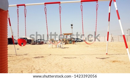 Photo of the camp and yellow sand and cars in Bahrain Desert.