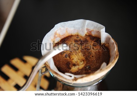 Unusual creative craft coconut shell pourover drip alternative coffee brewing Royalty-Free Stock Photo #1423396619