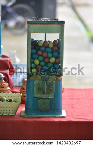 old gumball machine , gamble eggs in vintage gumball machine