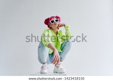 woman with pink hair wearing glasses