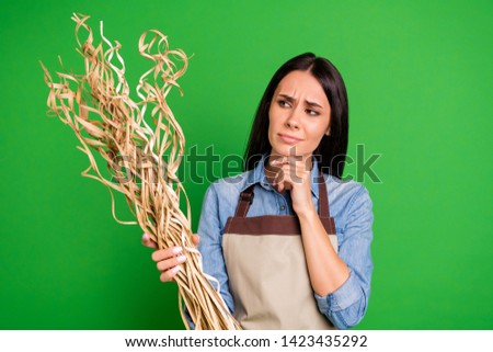Close up photo beautiful she her lady hands arms ikebana-like straw artistic flower arrangement have doubts about right using wear jeans denim shirt covered work apron isolated black grey background
