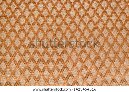 Texture of orange fabric with diamond or rombic pattern