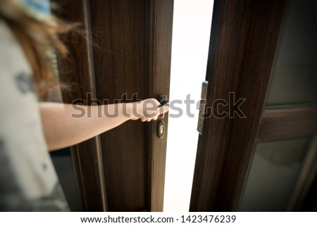 The woman's hand opens the new plastic door Royalty-Free Stock Photo #1423476239