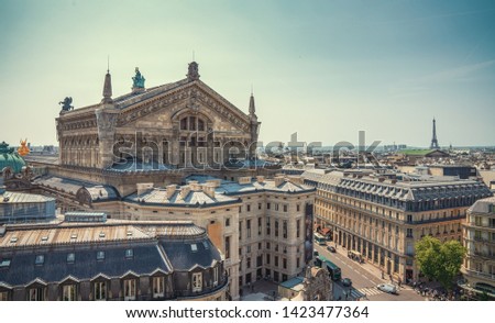 Paris streets with view on the opera house and famous paris eiffel tower on a sunny day with some sunshine Royalty-Free Stock Photo #1423477364