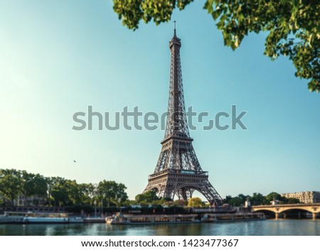 the famous paris eiffel tower on a sunny day with some morning sunshine reflects in blue water Royalty-Free Stock Photo #1423477367