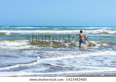 child playing on the sandy beach located in the delta of the Ebro called Trabucador