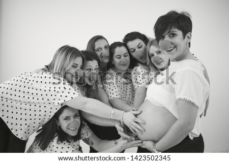 Photo shoot of a pregnant young woman with her best friends
