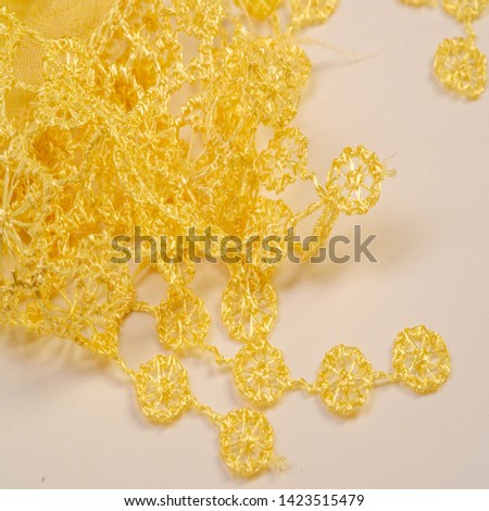Texture, background, pattern, postcard, silk fabric, female yellow scarf with lace wrappers. Use these fancy images to create your print and digital materials.
