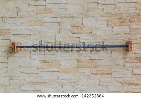 Wooden clothes line on the rock bricks
