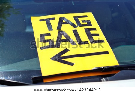 Sign advertising a local tag sale