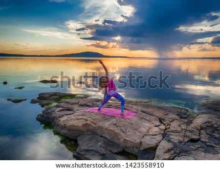 Aerial drone top view photo of Meditation girl on the sea during sunset. Yoga silhouette. Fitness and healthy lifestyle. - Image