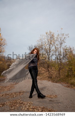  Young redhead woman with scarf in autumn park 