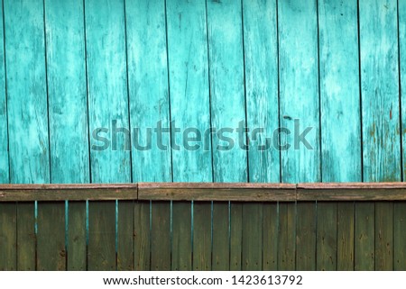 Old green grunge wooden fence and cyan wooden wall pattern. Abstract background and texture for design.