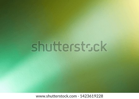 Intermittent light green ray of light with the transition to a yellow spot of light
