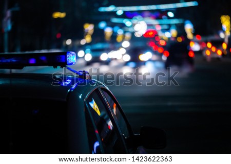 police car lights at night in city with selective focus and boke blur