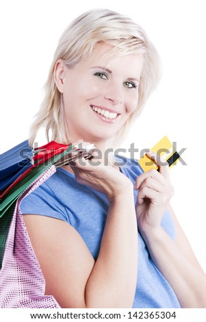 Credit cards and shopping bags holding the hand of a woman.