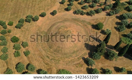 Aerial photo of archaeological site and monument of world famous Marathon tomb in the place of the historical battle between Athenians and Persians in city of Marathonas, Attica, Greece