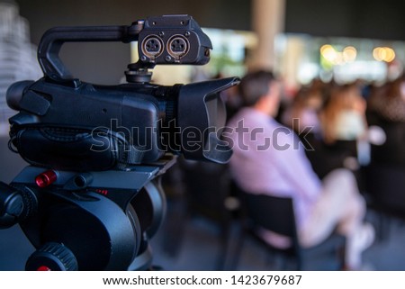 Video camera recording a conference