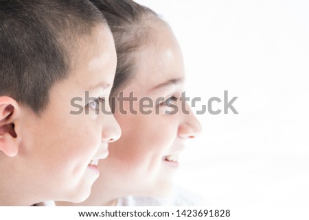 Brothers watching their pictures in television monitor