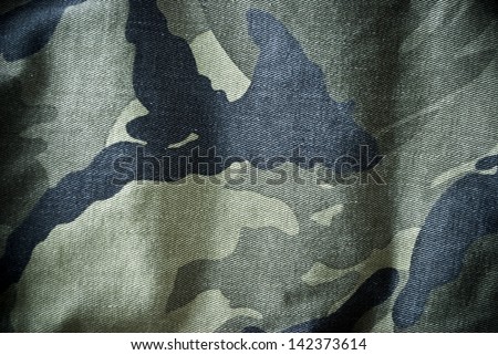 Green and black camouflage clothing background or texture