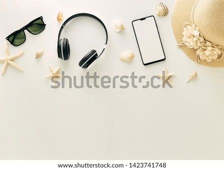 Straw hats, music headphones, sunglasses, shells on white background,  with empty space for text. Travel and fashion concept. Vacation summer sales.