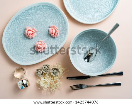 Round, square, oval white, blue, grey plate on pink, wooden, blue background, top view