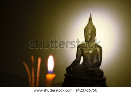 Buddha images worshiped with incense, candles in the holy days