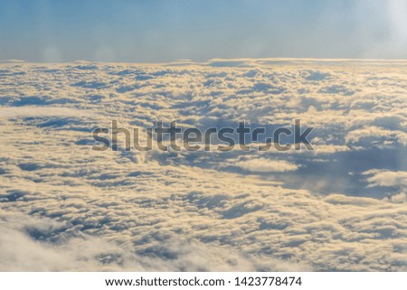 View on white clouds from airplane window