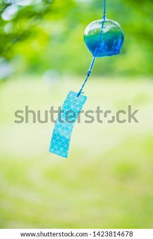 Wind chimes swaying in the wind. It is a traditional item of Japanese summer called "Furin".