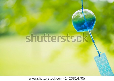 Wind chimes swaying in the wind. It is a traditional item of Japanese summer called "Furin".