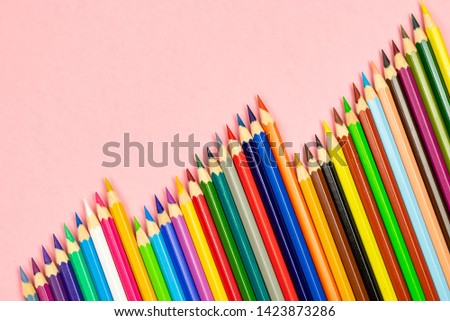 Color pencil with copy space isolated on pink background. Education frame concept.