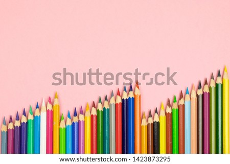 Close up of color pencils on pink background with clipping path. Education frame concept.