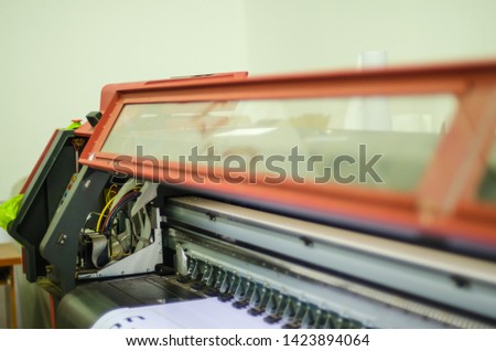 Large inkjet printing machine during work.