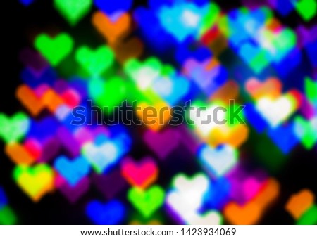 Blurred festive background with defocused colourful glitter formed a heart, bokeh in a shape of a heart. Original photographic effect. Pictures concept theme Love and St. Valentine's Day