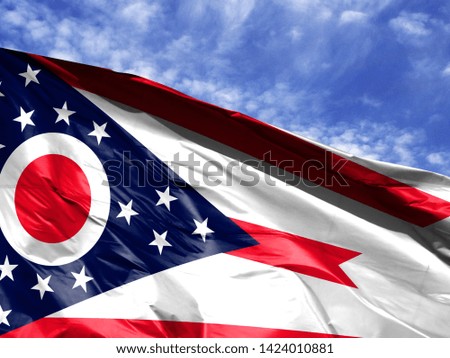 waving flag State of Ohio close up against blue sky