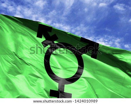 waving flag of Israeli Transgender close up against blue sky