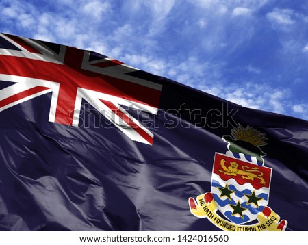 waving flag of Cayman islands close up against blue sky